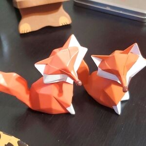 A pair of fox resin figurines